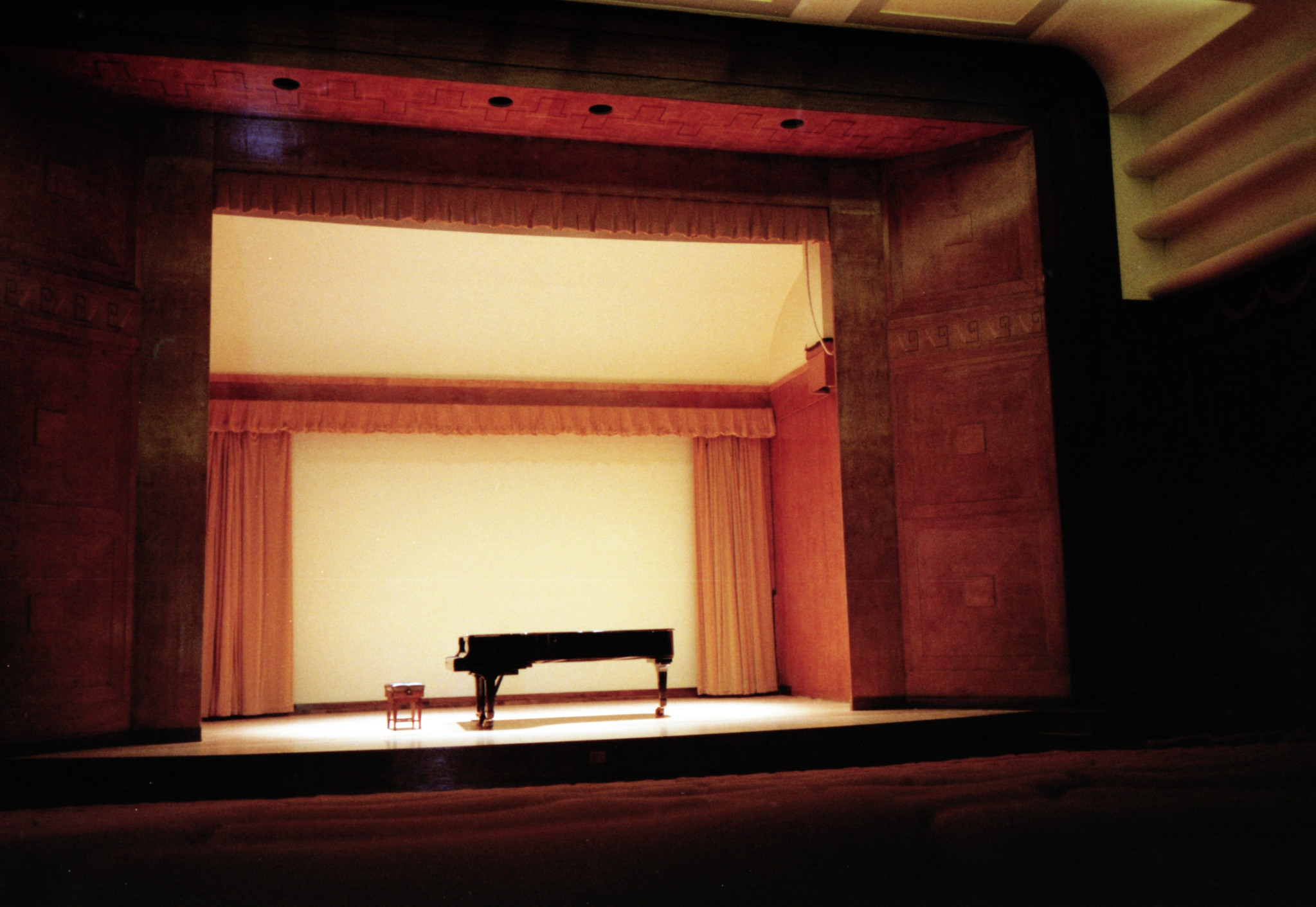 Grand piano on a concert stage with no performer