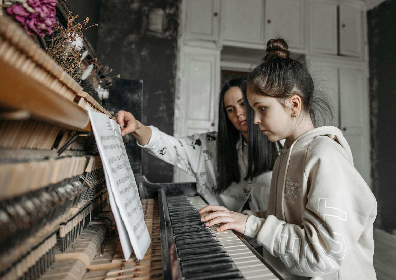 Music teacher using My Music Studio on a laptop while working with a student in a lesson.